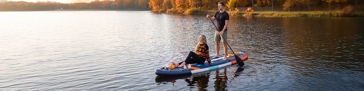 Paddling on an autumn lake at sunset